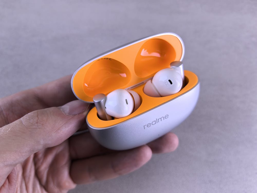 Close-up view of Halo Air Pro earbuds and charging case showing build quality and compact design